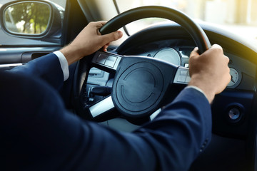 Man in suit on driving seat, closeup