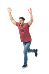 Young man in casual clothes running against white background