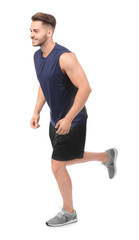 Obraz premium Young man in sportswear running against white background