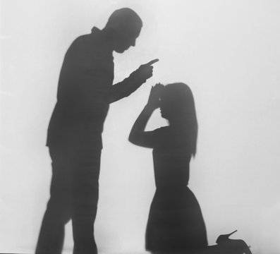 Silhouette of man shouting at his wife, on white background. Domestic violence concept