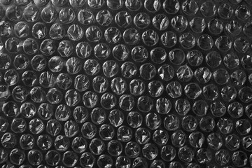 Plastic bubble wrap texture background on black