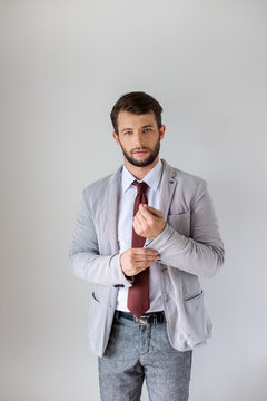 Man In A Grey Suit  Holding His Sleeve