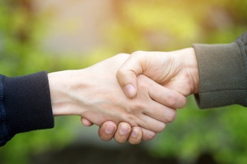 business hand shake between two colleagues. or Negotiate agreement.Good deal. Close-up of handshaking. Smooth business.