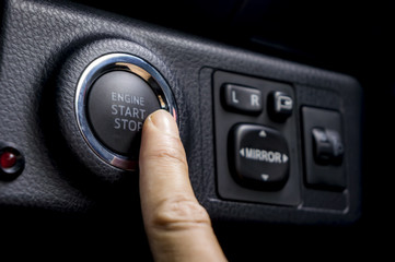 Car driver starting the engine keyless.