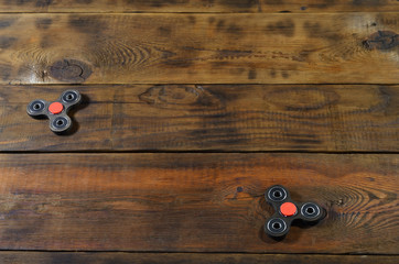 A rare handmade wooden fidget spinners lies on a brown wooden background surface. Trendy stress...
