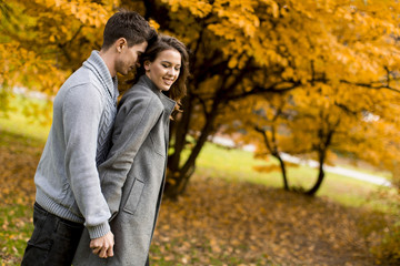 Lovely young couple in the autumn forest