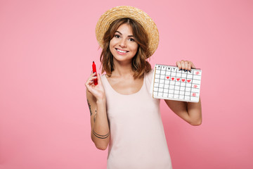 Portrait of a young smiling girl in summer hat