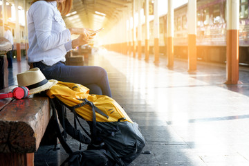 woman with her backpack sitting in train station