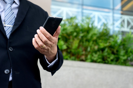 Businessman Stand In Front Of The Office Buliding