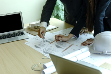architect or engineer man and woman working on table