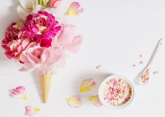 Fototapeta na wymiar flowers in waffle cone on wooden background