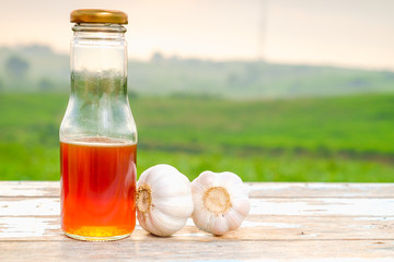 Fresh organic honey in glass and garlic  on old wooden with blurred background ,healthy nutrition,strengthening immunity, diet and treatment of flu.