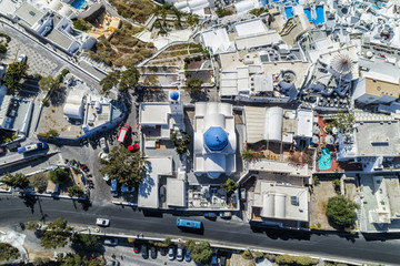 Aerial top view of street and blue dome church in Santorini Island, Greece