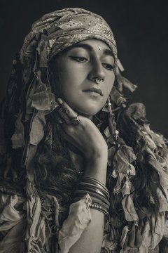 gypsy style young woman wearing tribal jewellery black and white portrait