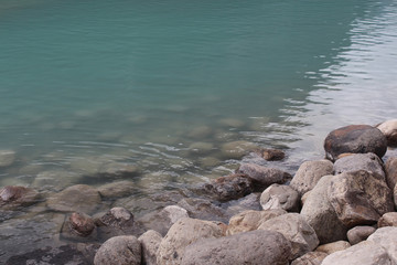 Fototapeta premium Stones in blue clear water