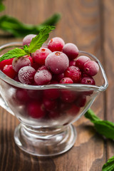 Frozen cranberries in a glass bowl 