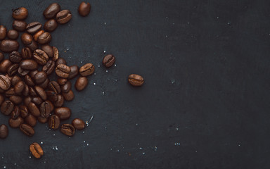 Coffee in beans on dark background. Abstract background texture.Coffee beans texture. Food background of coffee beans