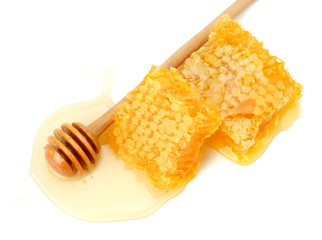 Honeycomb with honey dipper and honey isolated on white background