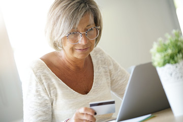 Senior woman buying on internet with credit card