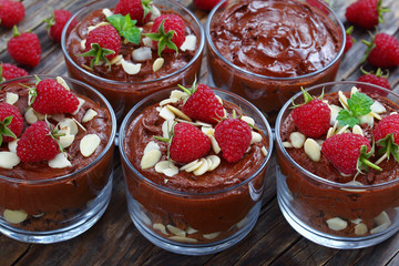 mousse in glass cups with fresh raspberries