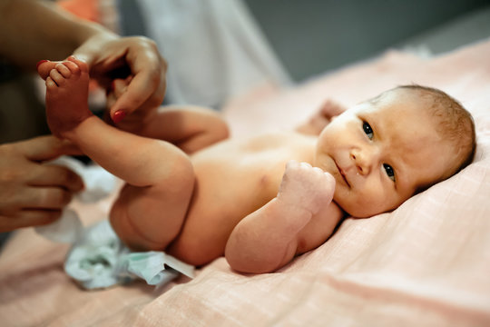 Parent Changing Newborn's Diapers