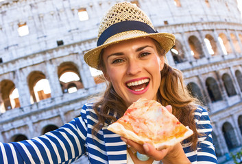 tourist woman in Rome, Italy with pizza slice taking selfie