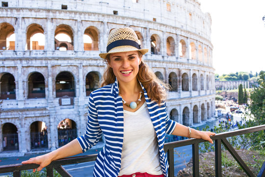 happy young woman in front of Colosseum in Rome, Italy