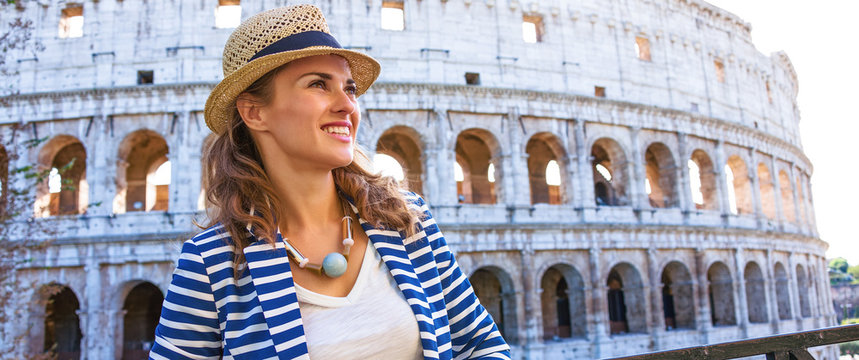 woman in front of Colosseum in Rome looking into distance