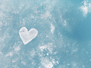Heart of ice. Texture of ice, toned. Christmas and New Year background. Winter background. St. Valentine's Day background.