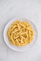 Pasta penne on a white plate