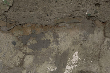 Old weathered rough gray cracked plaster concrete wall texture