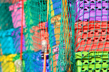 Colourful plastic crates with mesh rope