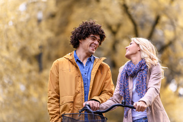 Young love couple walking in autumn park