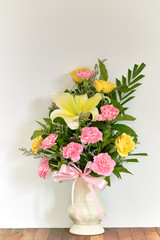 Bouquet of flowers in vase on wooden table