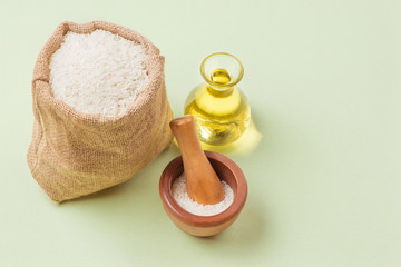 Rice oil in bottle glass and milk over green background.
