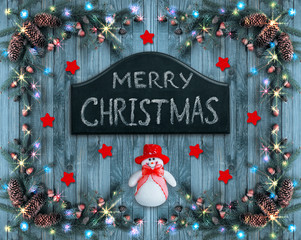 Christmas omposition with Snowman and signboard with greeting