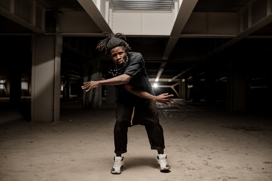 Dancing afro american man in black clothes
