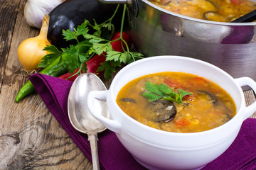 Rural dinner with soup and vegetables on wooden table
