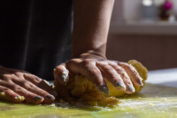 Cooking pie with rhubarb. The cook is kneading the sandy dough.