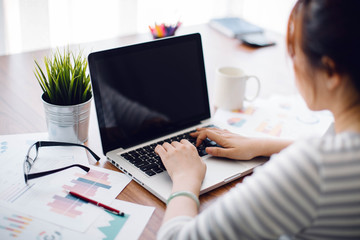 Fototapeta premium Beautiful young Asia woman working with laptop at home