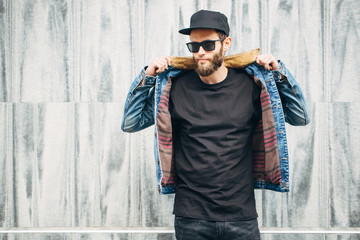 Hipster handsome male model with beard  wearing black blank  t-shirt with space for your logo or...