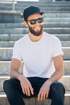 Hipster handsome male model with beard  wearing white blank  t-shirt with space for your logo