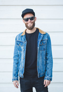Handsome hipster man smiling wearing trendy jeans clothes