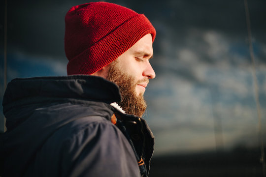 Man praying to God outside wearing winter clothes