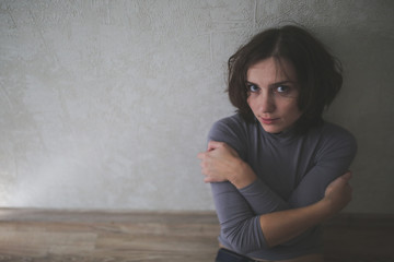 upset woman near gray wall,depression  loneliness