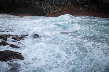 View of sea waves hitting rocks on the seashore
