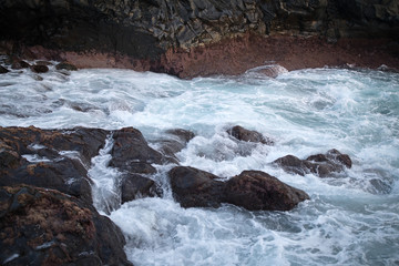 View of sea waves hitting rocks on the seashore