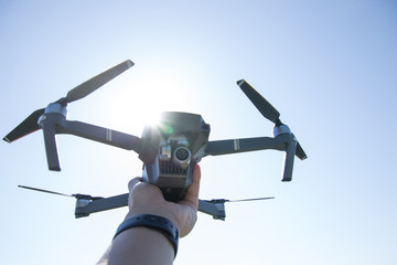 Hold a small drone in hand
