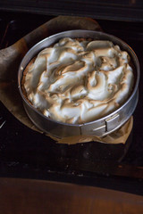 Cooking pie with rhubarb and meringues. The  cake in the form is just out of the oven.
