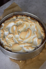 Cooking pie with rhubarb and meringues. The  cake in the form is just out of the oven.